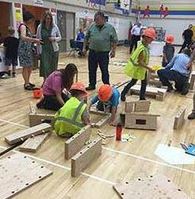 Photo of children in safety vests building things