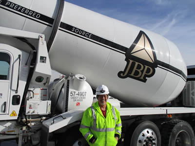 Employee standing in front of a readymix truck