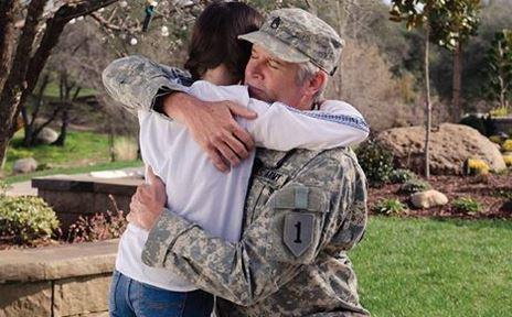 Veteran hugging his daughter