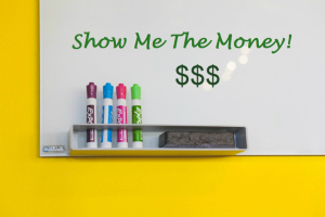 Whiteboard with dollar signs on it