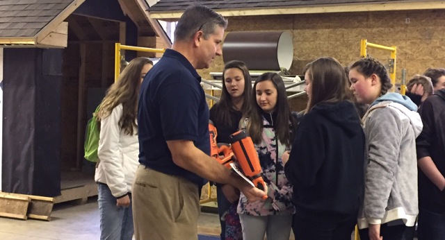 Teacher with students in constructional technology class.