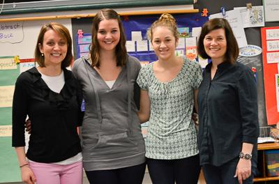 4 smiling teachers standing together