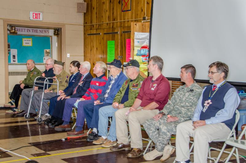 Veterans seated in the all-purpose room of Corl Street Elementary