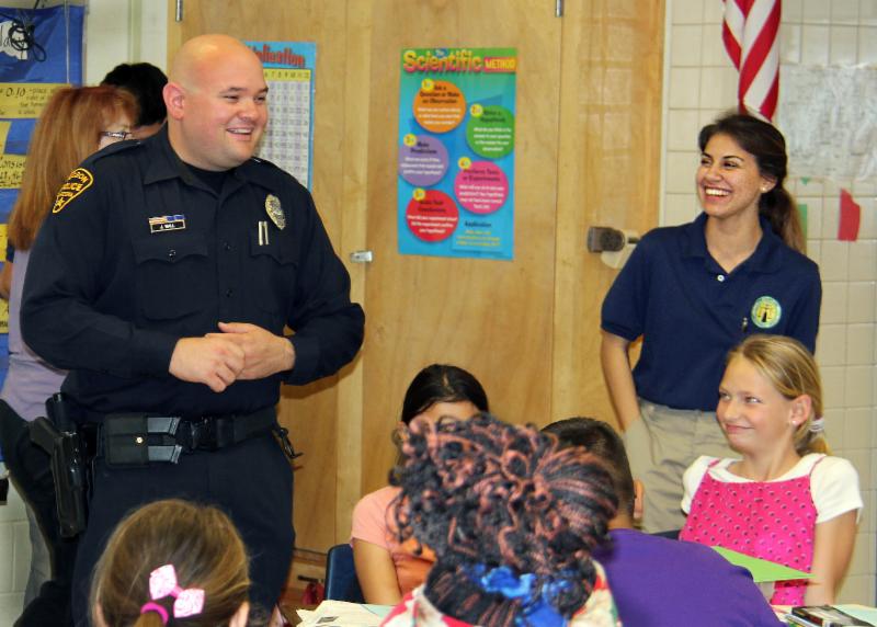 Det. Wall and Erica Rivera with elementary students