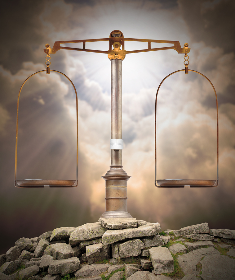 Weight scale on the peak against heaven. Divine justice concept.