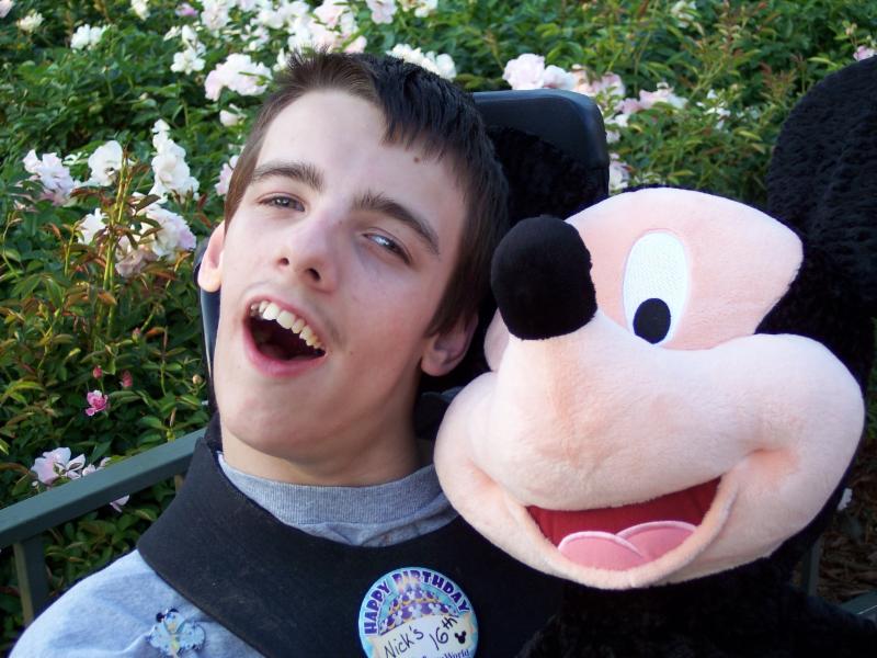 Nick with his micky mouse stuffed animal at Disney