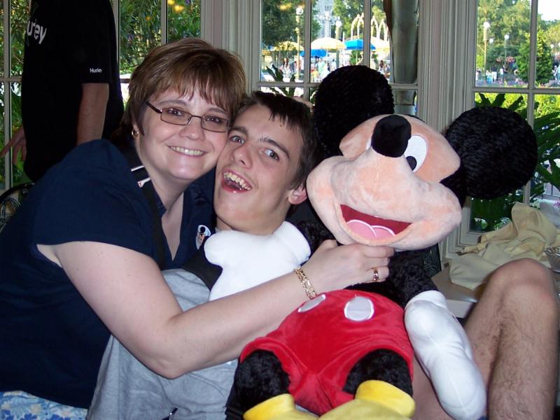 Julie, Nick, and a giant Mickey Mouse stuffed animal.