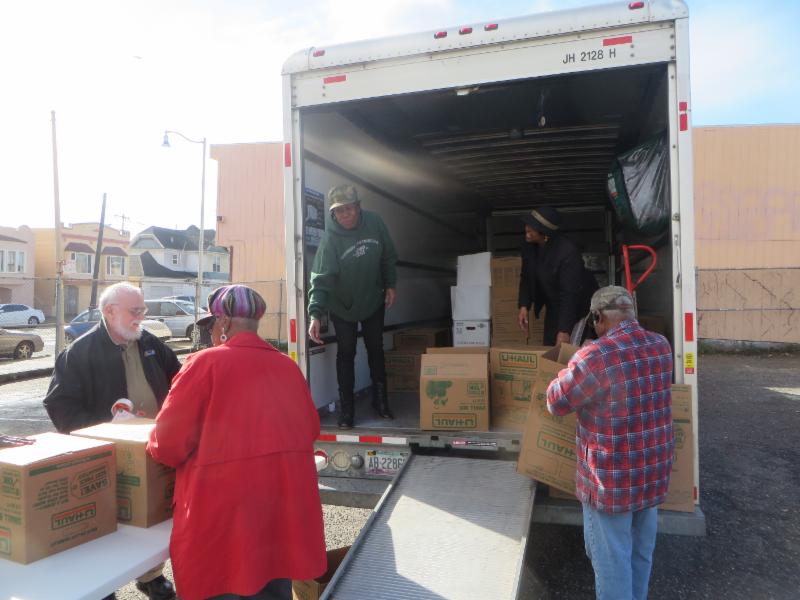 volunteers unloading food from truck